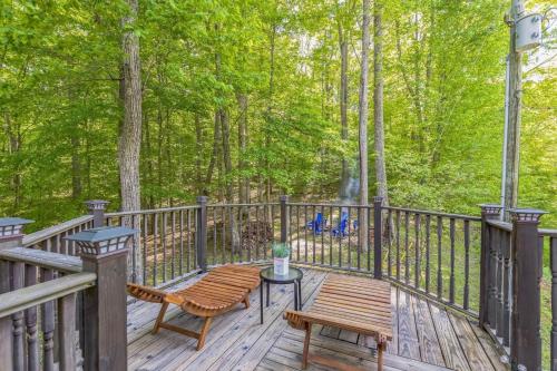 a wooden deck with a bench and a table at Puzzle Peak cottage in Nashville