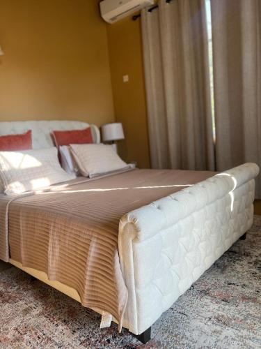 a bedroom with a large white bed in a room at Whitehall Villa in Negril in Negril