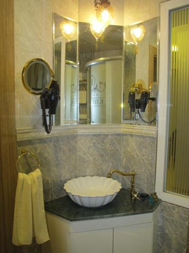 a bathroom with a sink and a mirror at Kaya Palas Hotel in Kırklareli