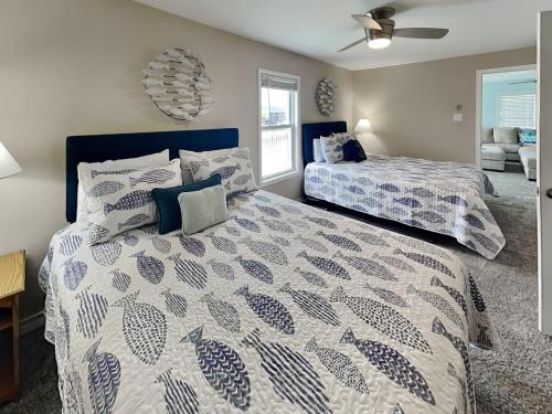 a bedroom with two beds and a ceiling fan at Dolphin Paradise in Aransas Pass