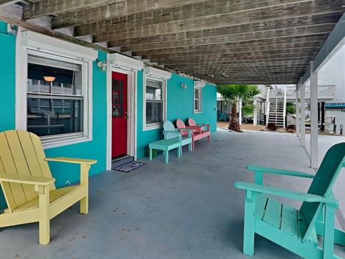 a group of chairs on the porch of a house at Dolphin Paradise in Aransas Pass