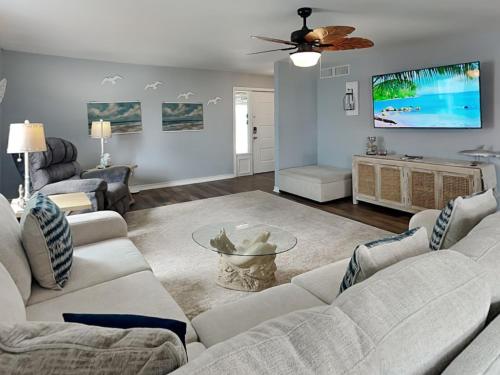 a living room with a couch and a tv at Dolphin Paradise in Aransas Pass