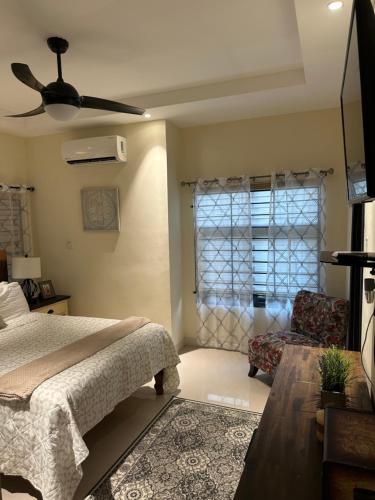 a bedroom with a bed and a ceiling fan at Villa Christine in Ocho Rios