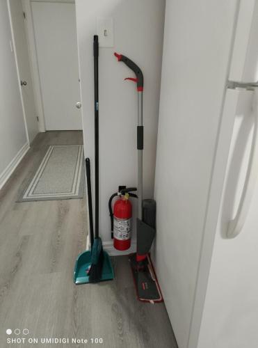 a room with two mop and a fire extinguisher at Tilto Executive suite in Saint John