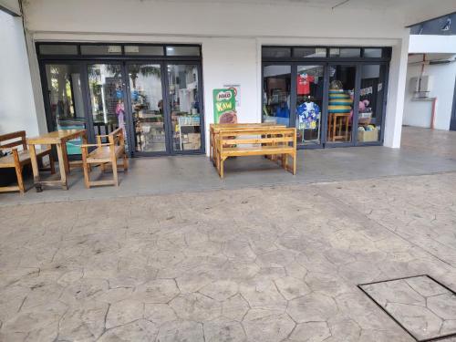 a store front with a wooden bench and tables at Swiss Garden resort residence by Moonlight in Kuantan
