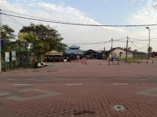 an empty street with orange cones on it at Muallim Home in Mersing