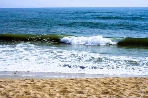 a wave in the ocean on a sandy beach at Oceanview Lodge - Saint Augustine in Saint Augustine