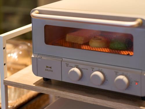 a toaster oven sitting on top of a counter at Hotel Resol Trinity Kanazawa in Kanazawa