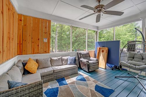 a living room with a couch and two chairs at Arcade, Ping Pong, Hot Tub, Gas Grill, & King Bed in Kernersville