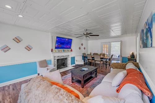 a living room with a couch and a fireplace at Arcade, Ping Pong, Hot Tub, Gas Grill, & King Bed in Kernersville