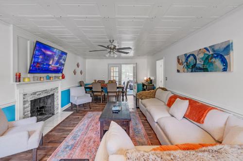 a living room with a couch and a fireplace at Arcade, Ping Pong, Hot Tub, Gas Grill, & King Bed in Kernersville