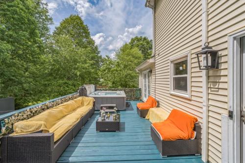 a deck with couches and a hot tub on a house at Arcade, Ping Pong, Hot Tub, Gas Grill, & King Bed in Kernersville