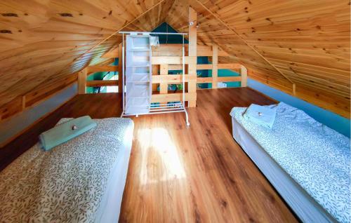a room with two beds and a bunk bed at 2 Bedroom Cozy Home In Kolsko in Kolsko