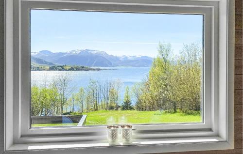 a window with a view of a lake and mountains at Nice Home In Ørsta With Sauna in Ørsta