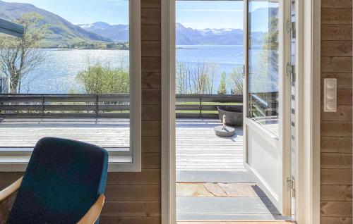 a door leading to a balcony with a view of a lake at Nice Home In Ørsta With Sauna in Ørsta
