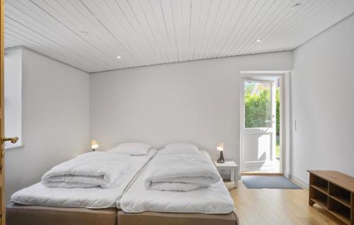 a white bedroom with a large bed with white sheets at Gorgeous Home In Millinge With Wifi in Millinge