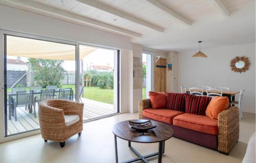 a living room with a couch and a table at Charmante Maison Proche Mer in Notre-Dame-de-Monts