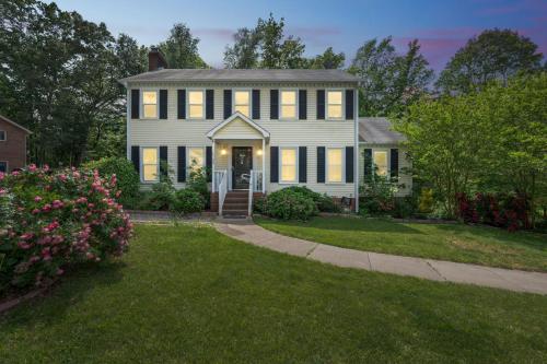 a white house with a porch and a driveway at Firepit Games Grill Hot Tub Arcade & King Bed in Kernersville