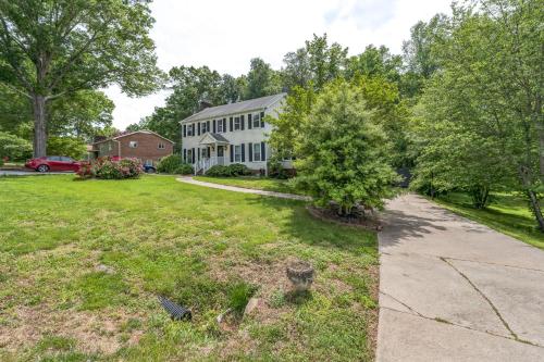 an empty yard with a house and a driveway at Firepit Games Grill Hot Tub Arcade & King Bed in Kernersville