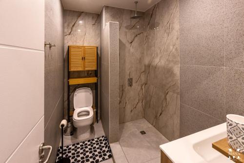 a small bathroom with a toilet and a sink at Matavai Two in Papeete
