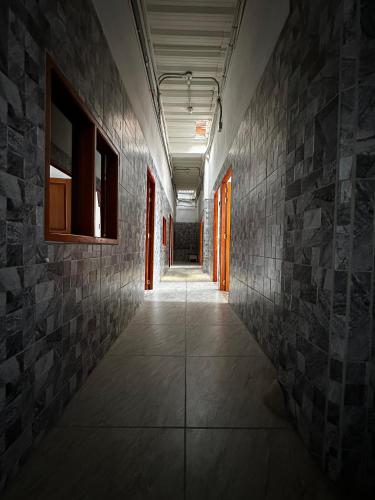an empty hallway with a stone wall and a corridorngthngthngthngthngthngth at LA PLAZOLETA in Doradal