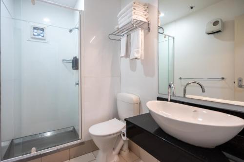a bathroom with a sink and a toilet and a shower at Mercure Wellington Central City Hotel and Apartments in Wellington