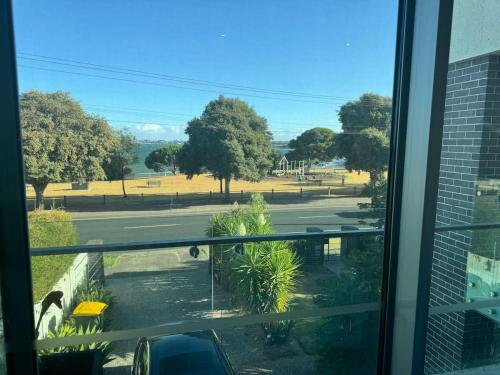 a view of a park from a window at Water Front at Geelong Holiday K Villa in North Shore