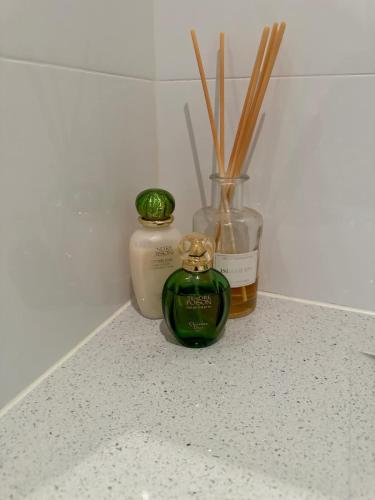 two bottles of essential oils and bamboo sticks on a counter at Water Front at Geelong Holiday K Villa in North Shore