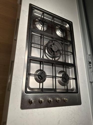 a stove top oven with a window in a kitchen at Water Front at Geelong Holiday K Villa in North Shore