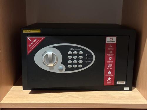 a microwave oven sitting on top of a shelf at Water Front at Geelong Holiday K Villa in North Shore