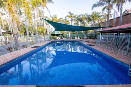 a swimming pool with a canopy over it at Batemans Bay Marina Resort in Batemans Bay