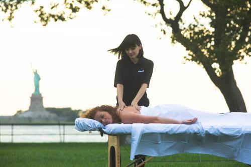 a woman standing on a bed with a girl standing on it at Collective Retreats Governors Island in New York