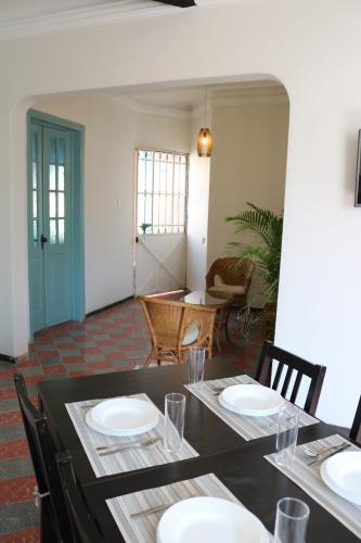 a dining room with a table and chairs and a room with a table and chairs at Amplio departamento remodelado in Mexico City