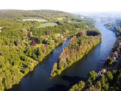 an aerial view of a river with trees on both sides at Tiny house in the Antwerp Kempen in Beulk