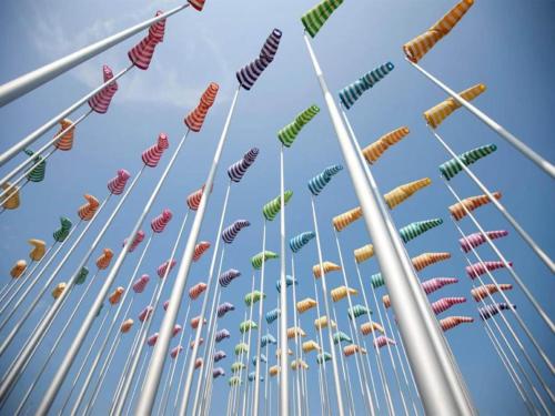a group of many different colored windsocks in the sky at Tiny house in the Antwerp Kempen in Beulk