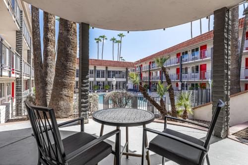 a patio with a table and chairs and palm trees at Tempe Oasis in Tempe