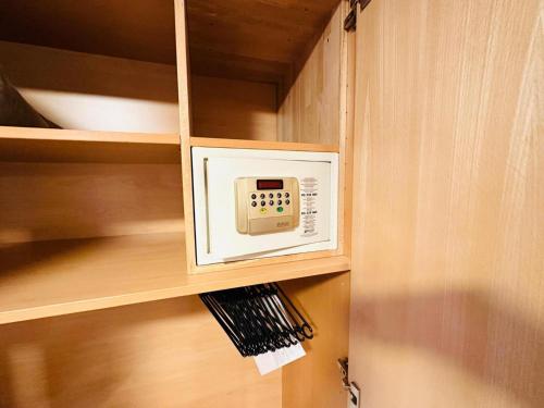 a microwave oven in a cabinet with a shelf at Apartment in Fügen near Spieljoch Ski Lift in Fügen