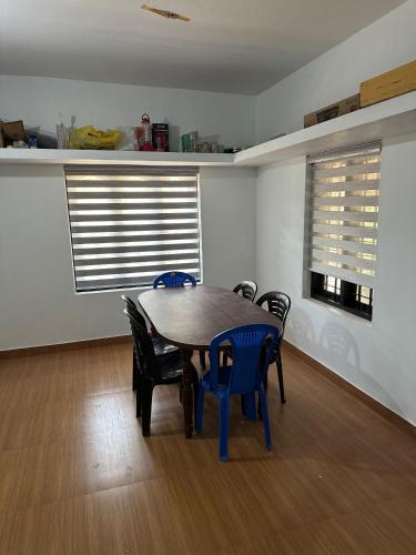 a dining room with a wooden table and chairs at Oryx Villai in Vythiri