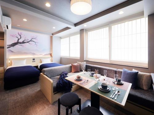 a living room with a couch and a table at Minn Shijo Omiya in Kyoto