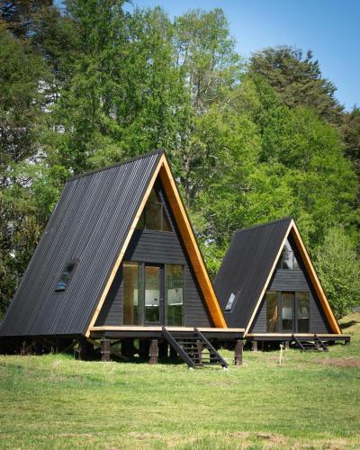 a house with two pitched roofs on a field at Alto Terralis in Minetué