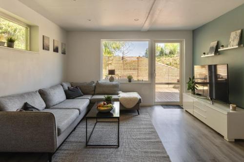 a living room with a couch and a table at Landvetter Apartment in Landvetter