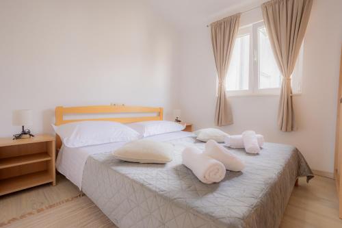 a bedroom with two white pillows on a bed at Apartment DuDo in Blace