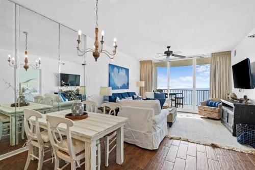 a living room with a table and chairs and a couch at Pool & Spa - Beachfront - Golf - King Bed in Gulf Highlands