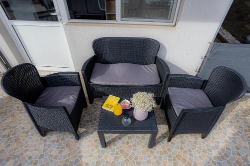 two chairs and a table on a patio with a tableablish at Apartment DuDo in Blace