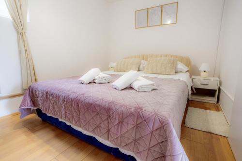 a bedroom with a bed with a purple blanket at Apartment DuDo in Blace