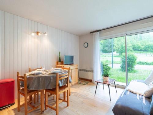 une salle à manger avec une table avec des chaises et une télévision dans l'établissement Appartement 6 pers. au cœur de St-Lary - FR-1-296-517, à Saint-Lary-Soulan