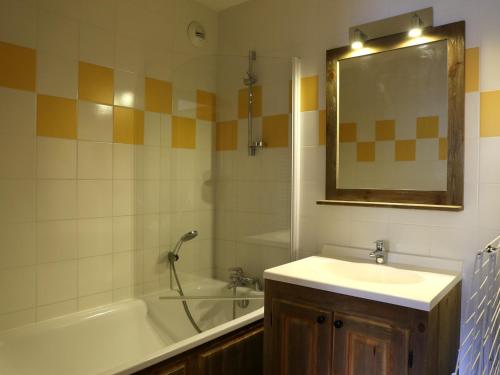 une salle de bain avec un lavabo, une baignoire et un miroir dans l'établissement Appartement spacieux 6 personnes avec balcon et WIFI - FR-1-508B-22, à Aussois