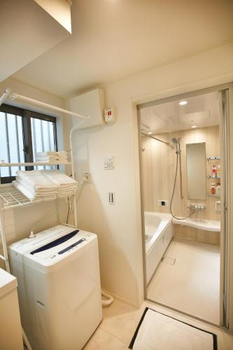a bathroom with a tub and a sink and a shower at SCD155 Private House for 9 with Rooftop in Ikebukuro, Direct Access to Tokyo's Core Commercial Districts in Tokyo