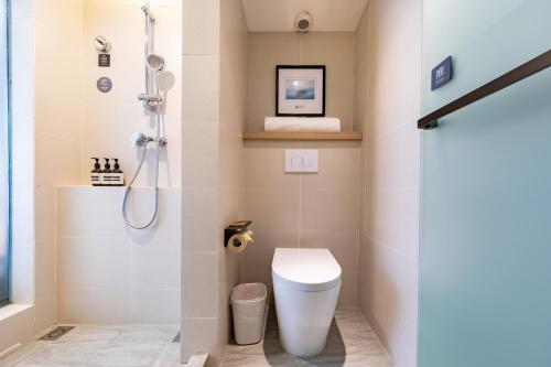 a bathroom with a toilet and a shower at Atour Light Hotel (Chengdu Hi-tech West Zone University of Electronic Technology) in Chengdu