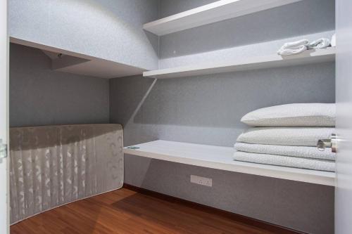 a room with a shelf with towels on it at I-City Luxury Condo, Shah Alam - Smarthome in Shah Alam